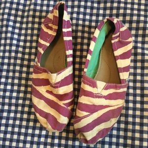 Purple Toms zebra striped with turquoise soles.